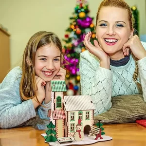 zimska koliba na stolu ispred devojaka